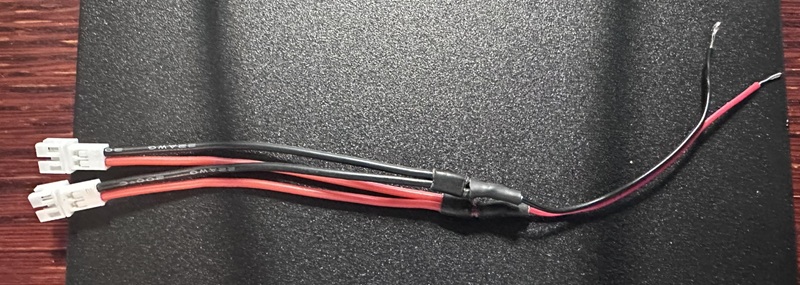 Two short pieces of wire with tiny-whoop battery connectors, solder into a wye. 